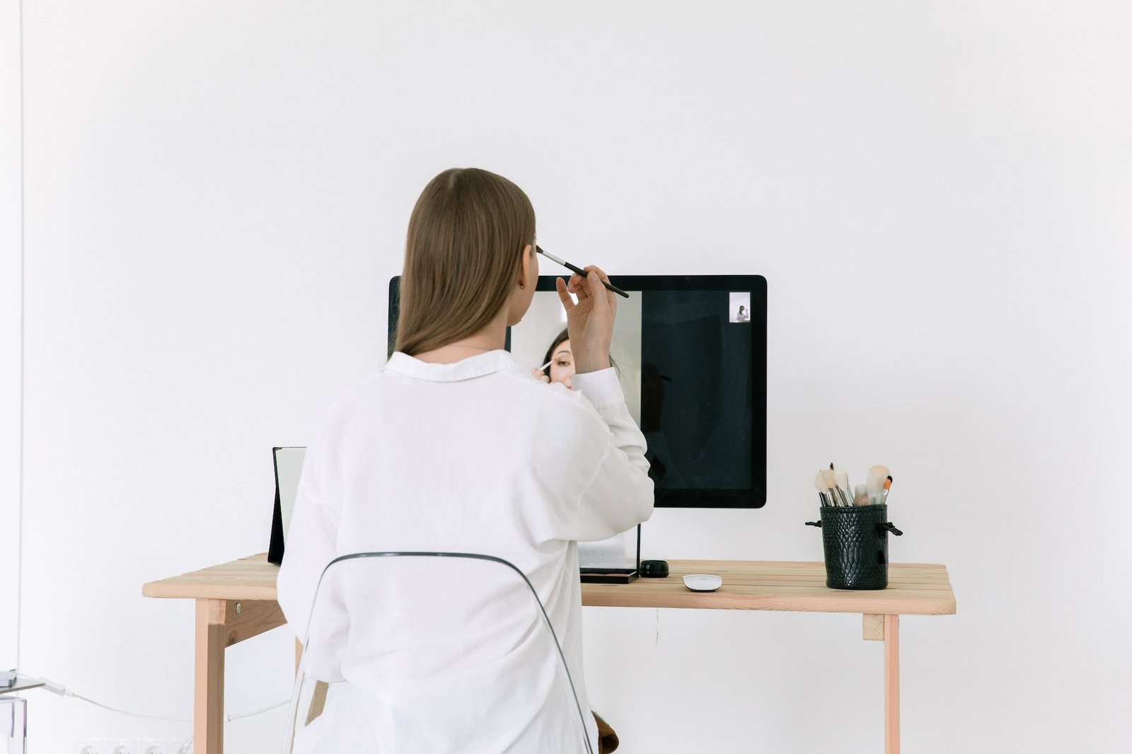 Photo Of Woman Applying Make-Up On Her Face